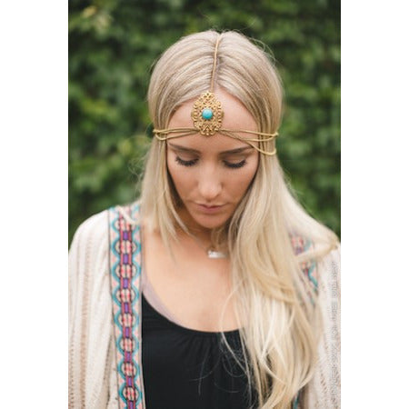Gold chain head chain featuring intricate gold cut-out headpiece with center turquoise stone, with adjustable clasp.